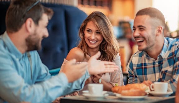group of people sitting at a table in a restaurant