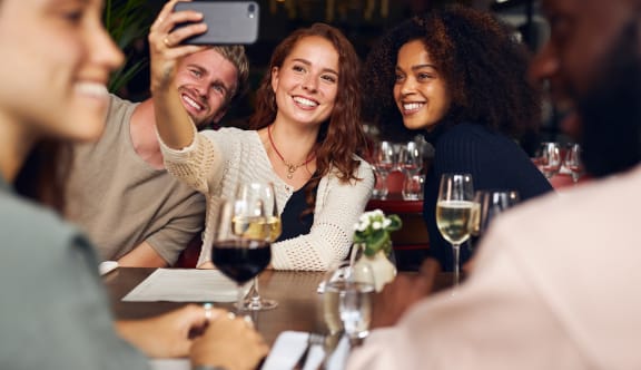 a group of people sitting at a table in a restaurant