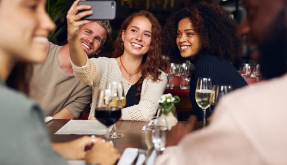 a group of people sitting around a table at a restaurant