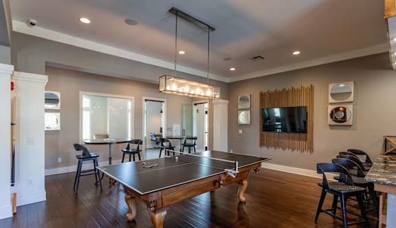 A dining room with a table and chairs.