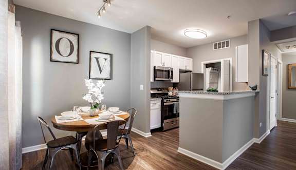 A kitchen with a dining table set for four.