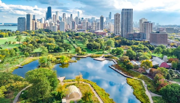 an aerial view of a park with a city in the background