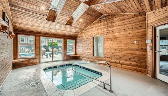 A wooden room with a glass pool table.