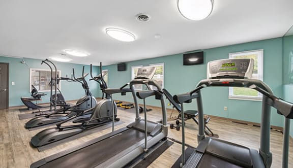 a gym with cardio equipment and exercise machines