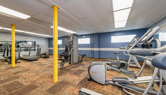 a gym with various exercise machines and weights