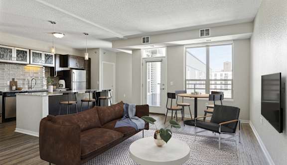 A living room with a brown couch and a white coffee table.