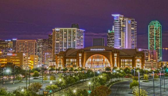A cityscape at night with a large building in the center.