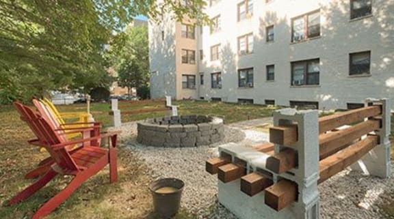 a backyard with a fire pit and a bench