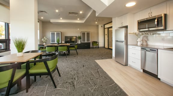 a kitchen and living room with a table and chairs