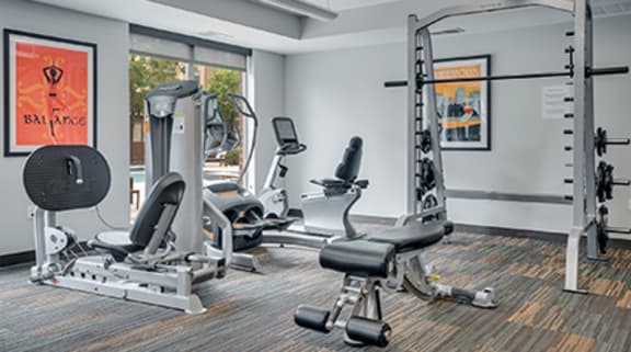 a gym with exercise equipment and windows in a building