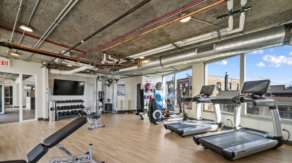 a gym with treadmills and other workout equipment in a loft at Lakeview 3200 Apartments, Chicago, IL, 60657