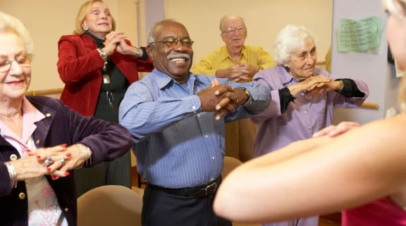 Elderly people doing a group exercise
