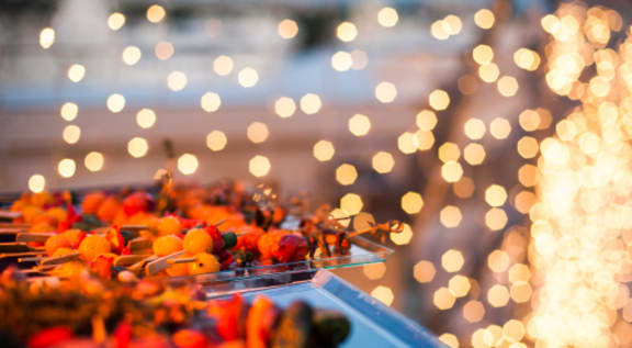 a close up of a tray of food with lights in the background