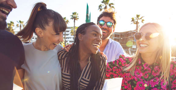 a group of young people laughing and smiling at the beach at Hillsdale Garden Apartments, San Mateo