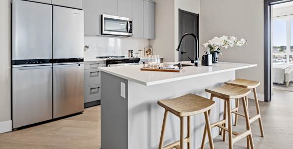 Kitchen with stainless steel appliances at The Woods at 180 Kanata Avenue Apartments, Ontario