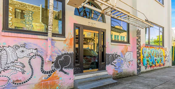 A building with a mural of a snake on its wall.