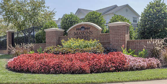 A sign that says Masons Keepe in front of an apartment complex.