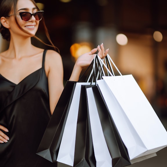 a woman holding several shopping bags