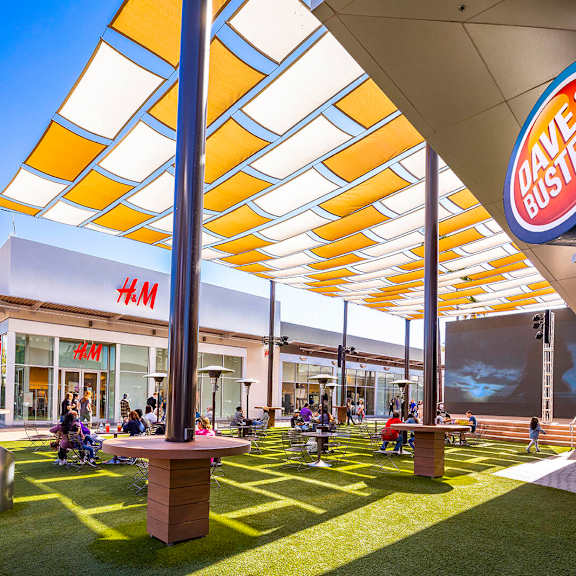 A Dave and Buster's restaurant with people sitting and standing around the area. at The Link Apartments, Arizona, 85201