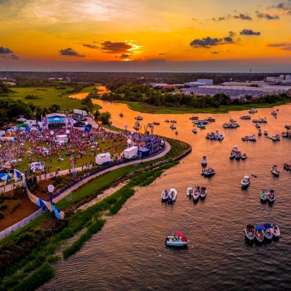 an aerial view of the festival on the water at sunset