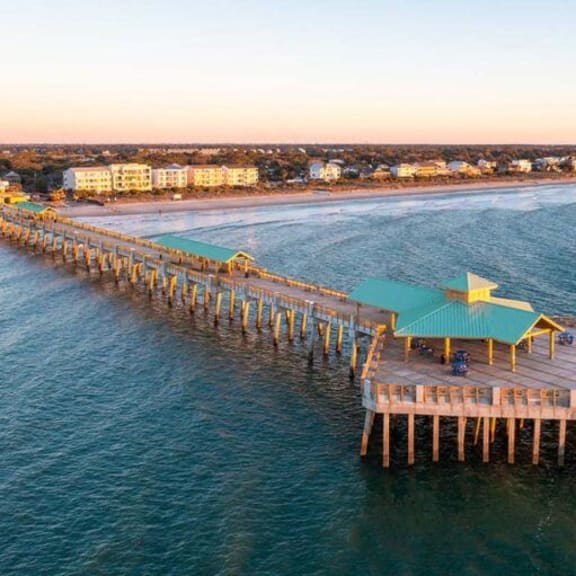 an aerial view of the pier at the beach