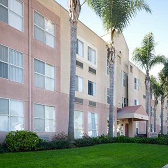 a building with a green lawn in front of it.