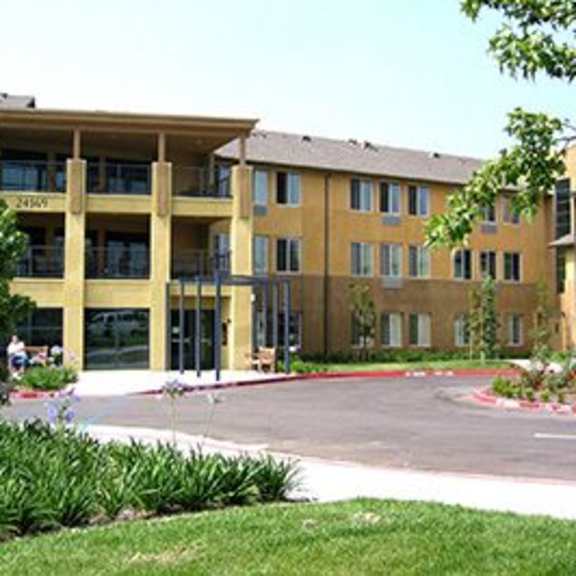 a large building with a parking lot in front.