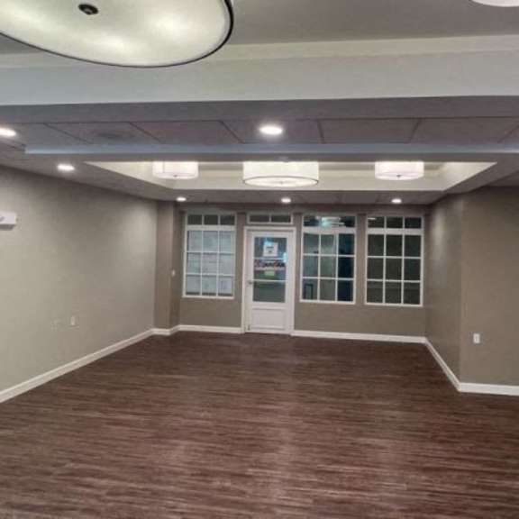a room with brown flooring and a white ceiling.