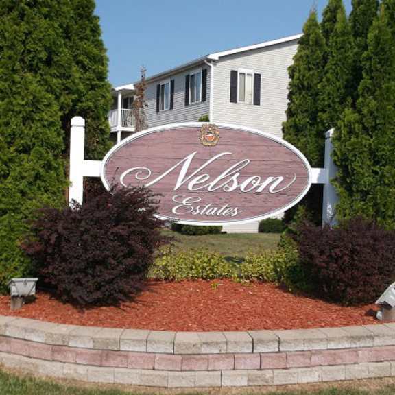 welcoming property sign at nelson estates apartments,1815 raleigh ave, kendallville, in 46755apartments, kendallville, in