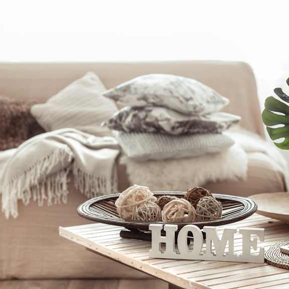 a coffee table in a living room with a plate of cookies on it