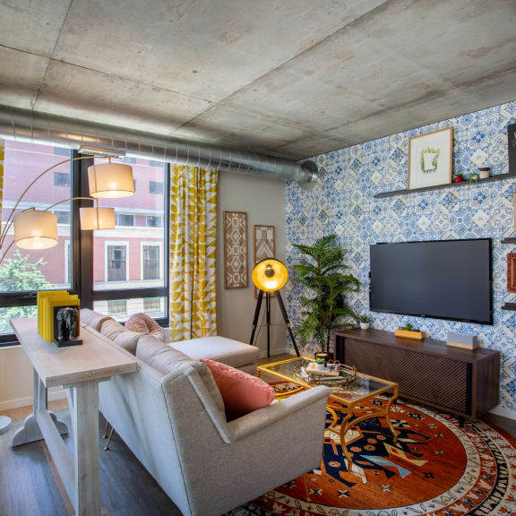 a living room with blue and yellow wallpaper and a couch