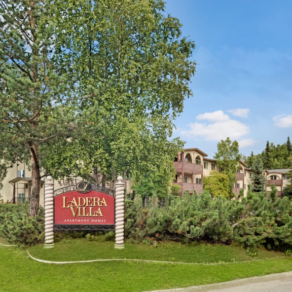 a view of the laforte villas sign with apartment buildings in the background