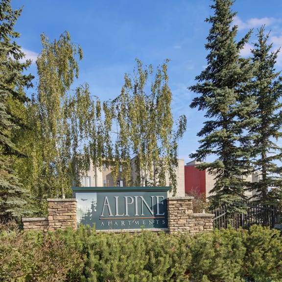 a sign at the entrance to the alpine village apartments