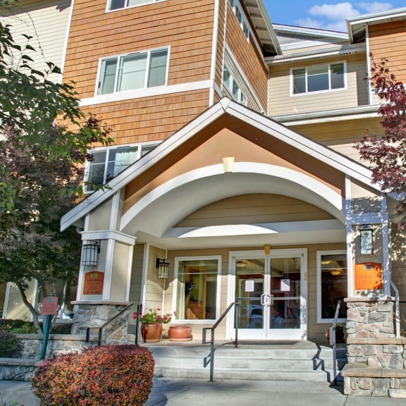 the front entrance of a building with steps and a porch