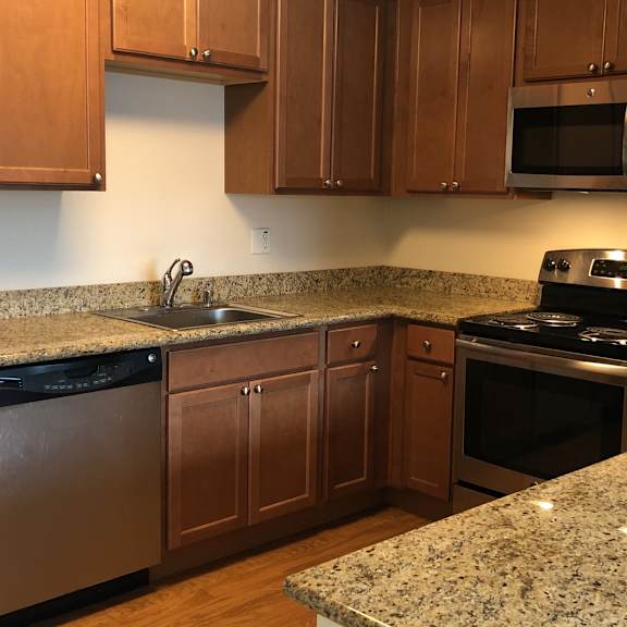 a kitchen with granite countertops and stainless steel appliances.
