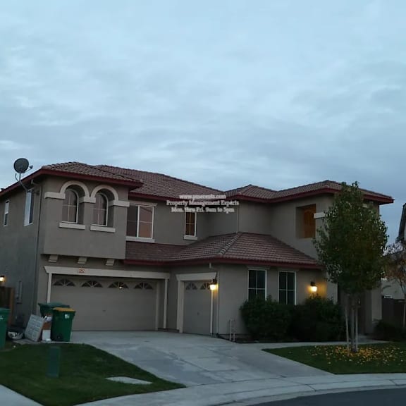 a house with a red roof and a garage is shown.