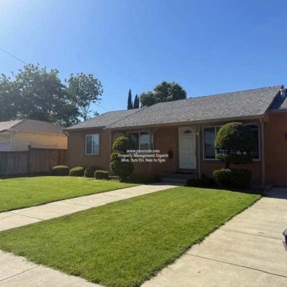 a house with a brown roof and a white garage door.