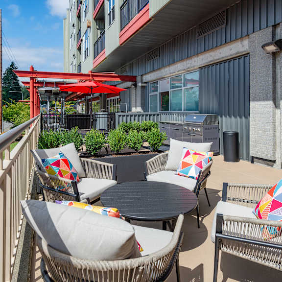 A modern outdoor living space with a fire pit and comfortable seating.
