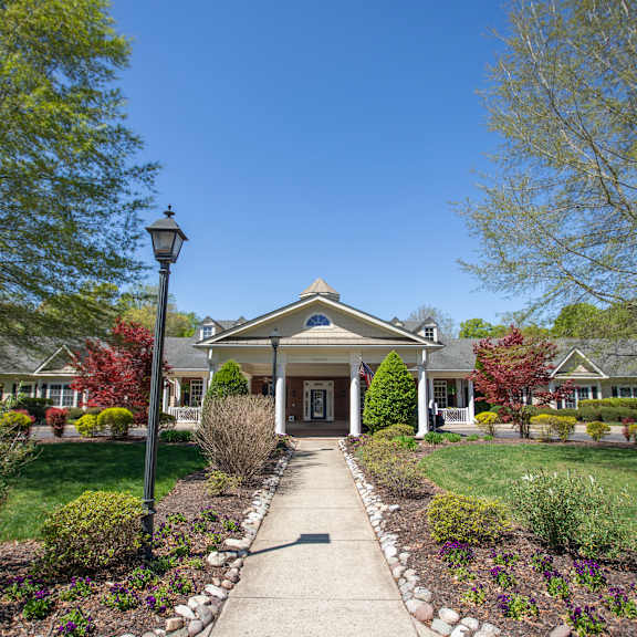 a house with a front yard and a lamp post.at spring arbor of williamsburg, williamsburg, virginia