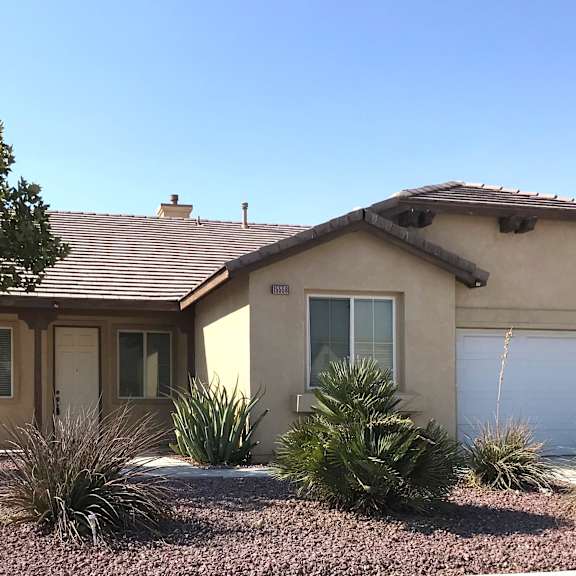 a house with a brown roof and a white garage door.
