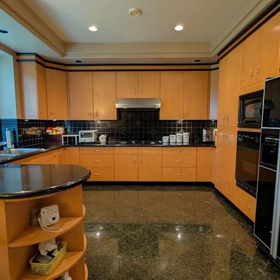 a kitchen with wooden cabinets and black appliances.
