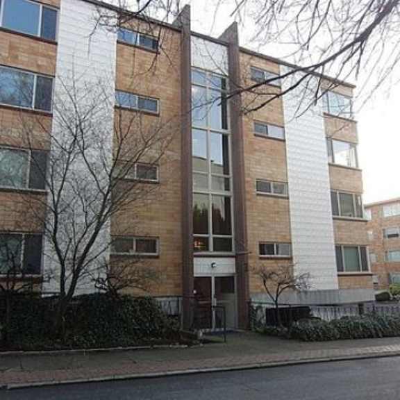a tall brick building sitting next to a street
