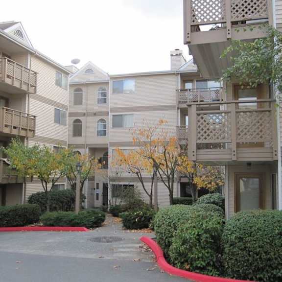 a parking lot in front of an apartment building