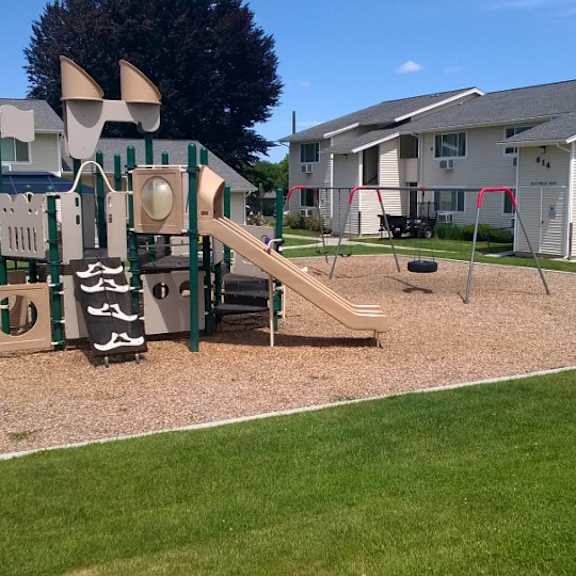 a playground with a slide and monkey bars