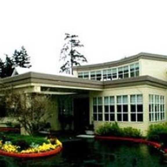 a large building with a pond in front of it