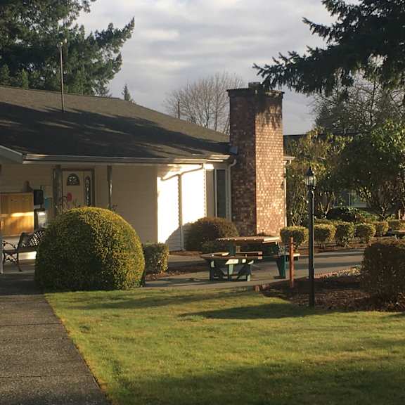 a house with a picnic table in the front yard