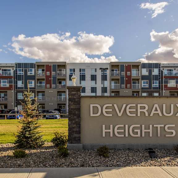 a sign that says deveraux heights in front of a building.