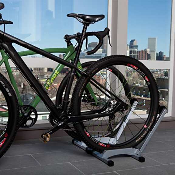 a bike on a stand in front of a window