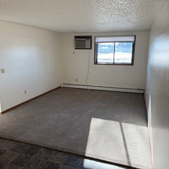 a room with a window and a tiled wall.