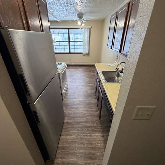 a stainless steel countertop in a room with a window.